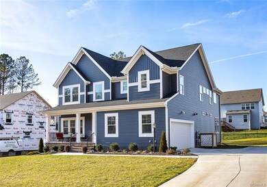 Exterior front of the home view to the paved driveway and the attached 2 car garage