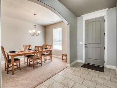 Tiled entryway boast a tall front door entryway wi