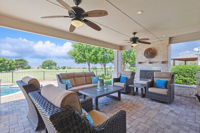 View of patio with ceiling fan and an outdoor livi
