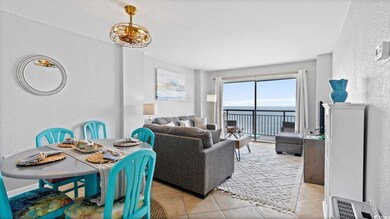 Living area with a textured wall and light tile patterned floors