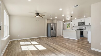 This stunning kitchen is designed to impress — featuring sleek black accent pendant lights elegantly hanging above the breakfast bar. The custom cabinetry extends all the way to the ceiling, adding a touch of sophistication and maximizing storage. Brand-new appliances complete the space, blending luxury and functionality for modern living.