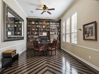 The office is gorgeous with the unique wood flooring and built-in bookshelves.