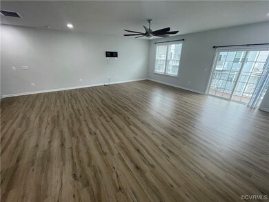 Hardwood floored empty room featuring ceiling fan