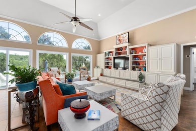 Living room with high vaulted ceiling and a ceili