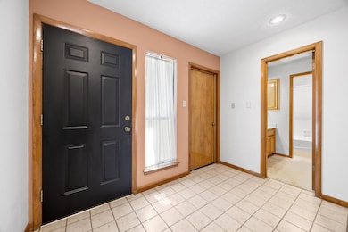 Entryway with light tile patterned flooring, base