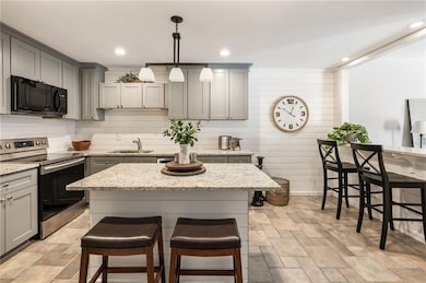Functional kitchen with eat in island and dining bar overlooking living room