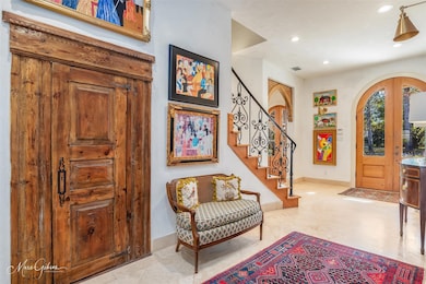 Tiled foyer entrance featuring french doors
