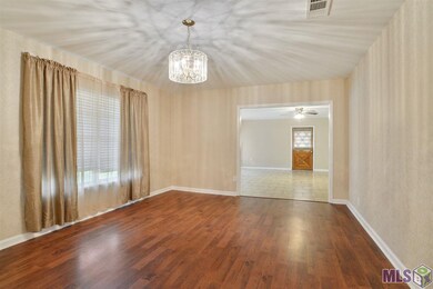 Large size dining room with window draperies and a lovely chandelier.