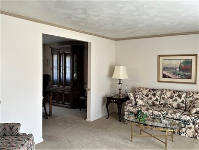 NEUTRAL WALL TO WALL CARPETING AND CROWN MOLDING.