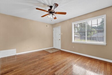 Unfurnished room with ceiling fan and wood-type fl