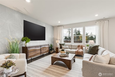 Enjoy hosting with ample great room with large windows for natural light. Photo is representational. Actual home is under construction. Colors, materials, and features may vary. See site agent for details.