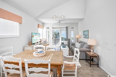 Tiled dining area with vaulted ceiling and ceiling