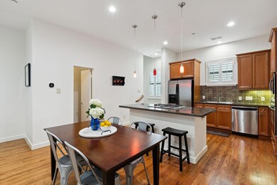 Kitchen with decorative light fixtures, backsplash
