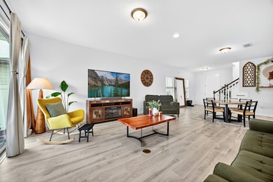 Living area featuring light wood finished floors and stairs