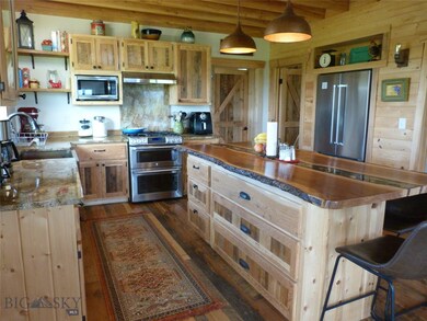 Custom barnwood cabinets and flooring. Copper sink
