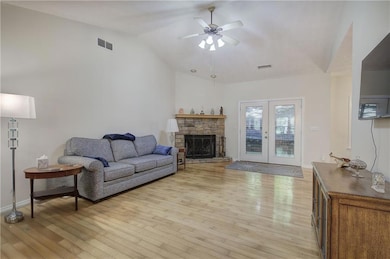 The Great Room features hardwood floors, a vaulted ceiling, a gas-log fireplace, and has plenty of room for furniture placement.