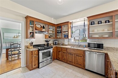Kitchen featuring exhaust hood, tasteful backsplas