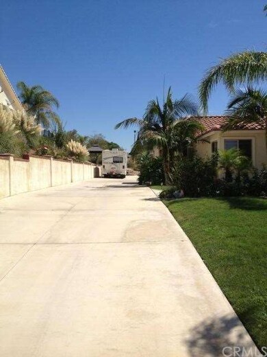 Driveway of home leading to an oversized 4 car gar