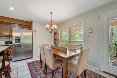 Dining room featuring a chandelier, ornamental mol