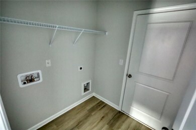 Washroom featuring hookup for an electric dryer, l