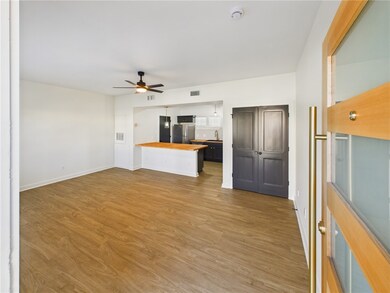 Unfurnished living room featuring light wood-style flooring and ceiling fan