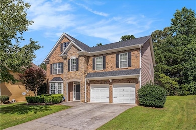 View of front of property with driveway, a front lawn, a garage, brick siding, and a shingled roof
