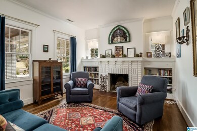 fireplace is flanked by built in bookcases