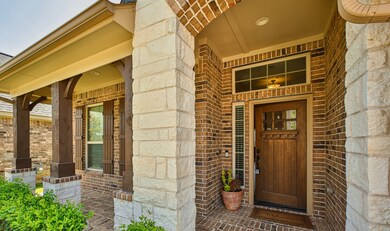2322 Falcon Brook Drive boasts a Large Covered Front Porch with Full Brick and beautiful Front Door Entry.