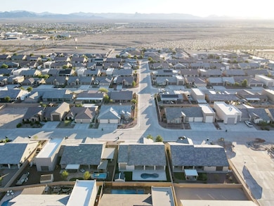Aerial overview of property's location with nearby suburban area and a mountain backdrop