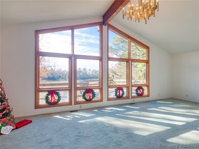 Bonus room with an inviting chandelier, beamed cei