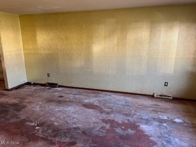 Unfurnished room featuring concrete floors