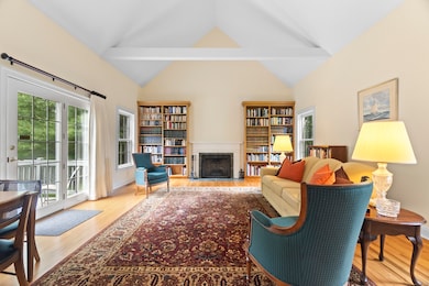 Spacious and inviting: This stunning family room features soaring cathedral ceilings, a cozy fireplace, and custom built-in bookshelves-perfect for relaxing or entertaining.