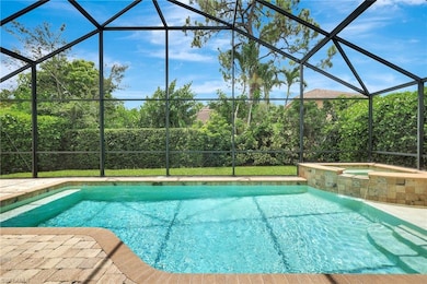View of swimming pool with a lanai and a pool with connected hot tub