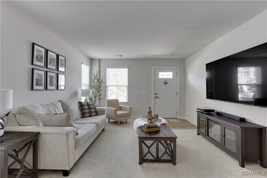 Living area featuring light colored carpet, basebo