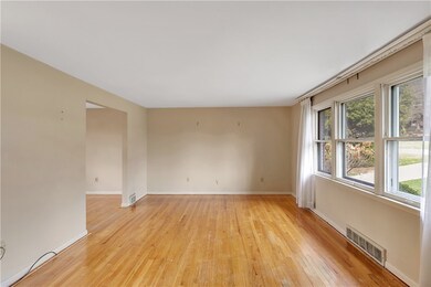 Large front Living Room with exposed hardwood! Car