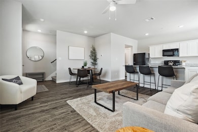 Living area with stairway, dark wood-type floorin