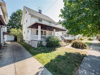 Bungalow featuring a front lawn and covered porch