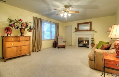 Large Family Room with gorgeous gas logs (natural gas), overhead lighting, ceiling fan and direct access to garage & deck