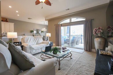 Living room featuring ceiling fan with notable cha