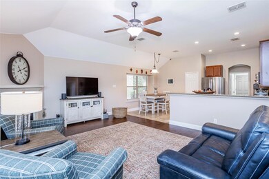 Living room featuring ceiling fan, lofted ceiling,