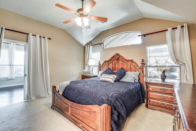Carpeted bedroom featuring vaulted ceiling and cei