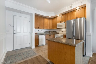 Kitchen featuring crown molding, white appliances,