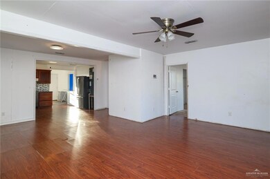 Spare room with visible vents, dark wood finished floors, and a ceiling fan