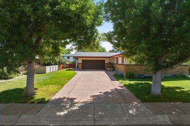 Ranch-style house featuring concrete driveway, a garage, and brick siding
