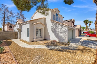 Mediterranean / spanish-style house featuring stucco siding, a chimney, a tiled roof, driveway, and roof mounted solar panels