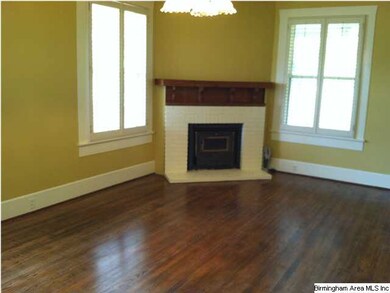 Living room has free-standing wood-burning heater 