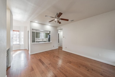 Unfurnished living room featuring ceiling fan, a t