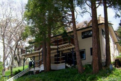 FRONT OF HOME SHOWING TWO DECKS AND TREES, DIRECTL