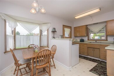 Eat-in kitchen, bay window, and a small side porch