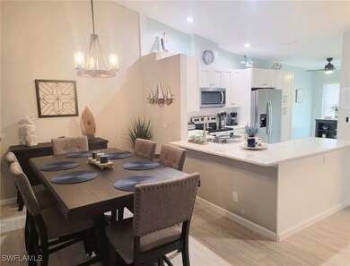 Dining room with light wood-style flooring, a chandelier, a ceiling fan, and recessed lighting